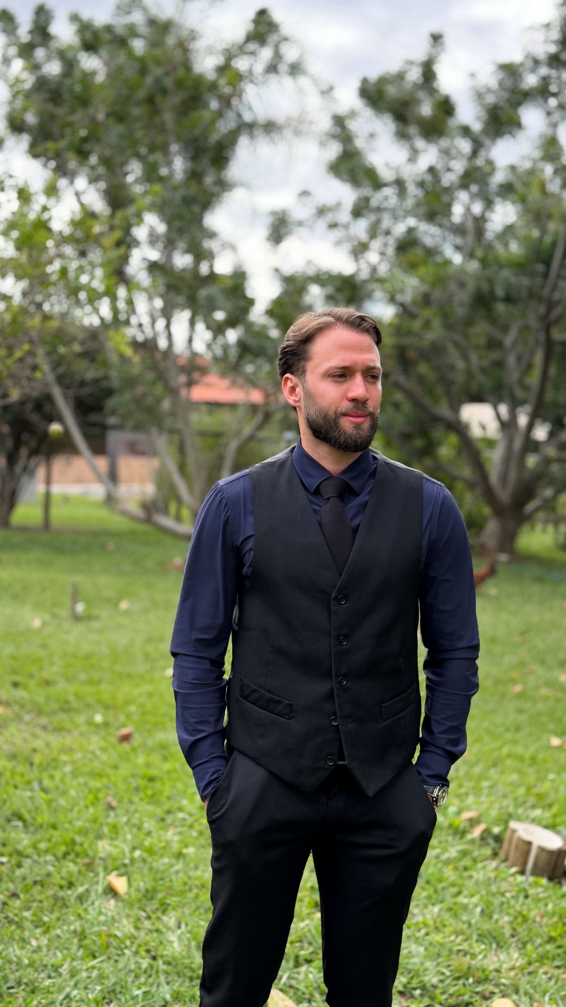 Igor Salaroli wearing a dark vest and tie outdoors